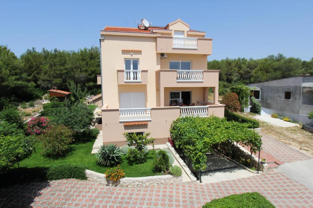 a villa with a view of the garden at Apartments Kala in Sveti Filip i Jakov