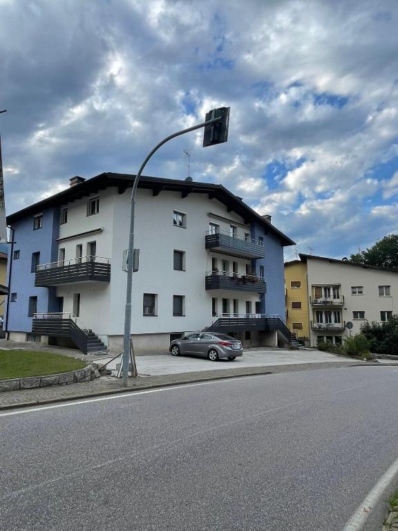 a car parked in front of a white building at Palazzina Rosa in Spormaggiore