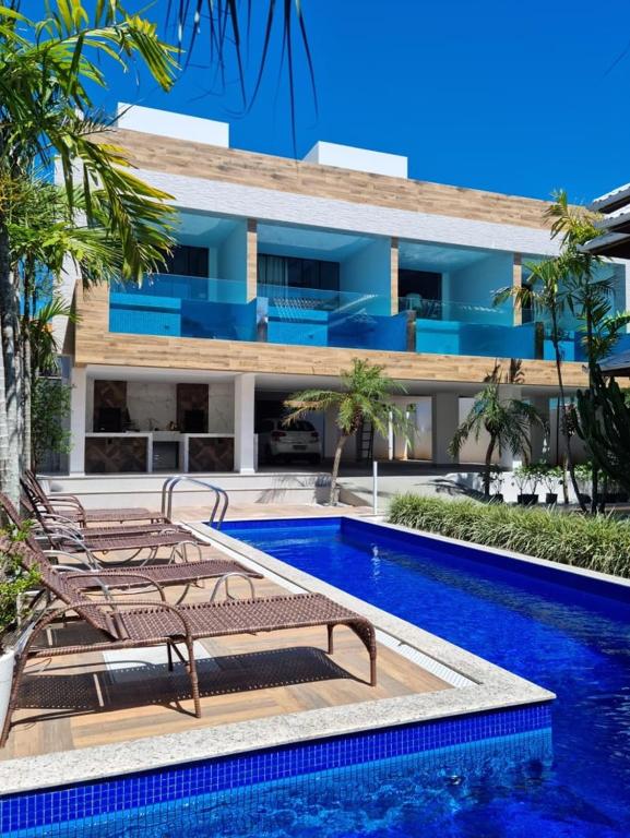 a villa with a swimming pool and a resort at Pousada Exclusive in Florianópolis