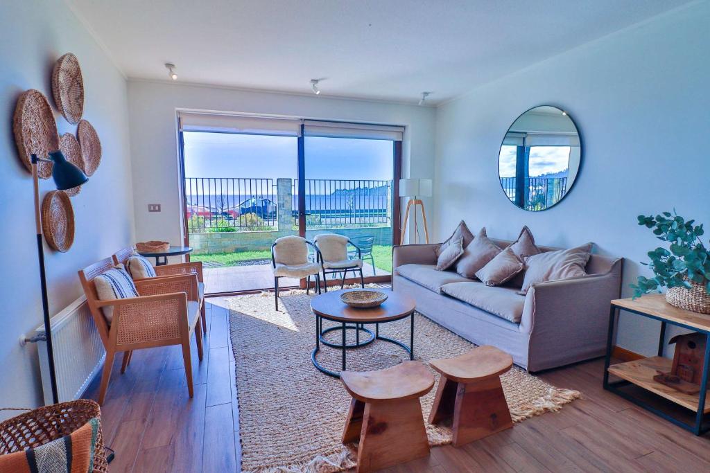 a living room with a couch and a table at HOM I Depto familiar a pasos del lago in Puerto Varas