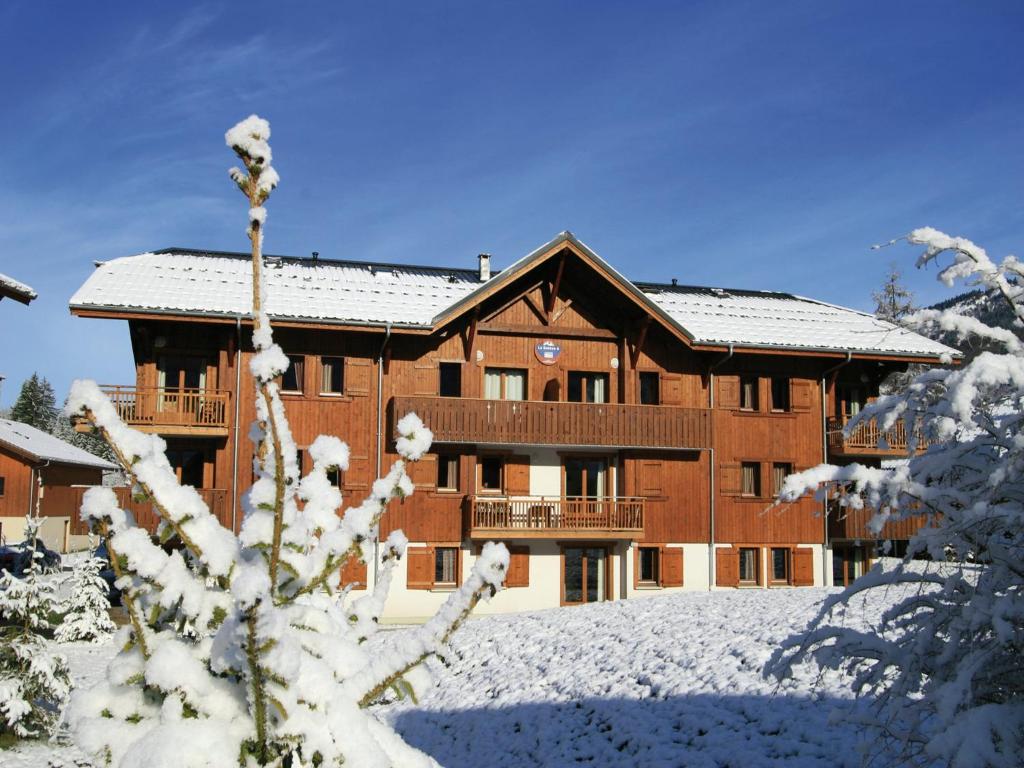 a large building with snow on the ground at Charming Mountain Getaway in Samoëns