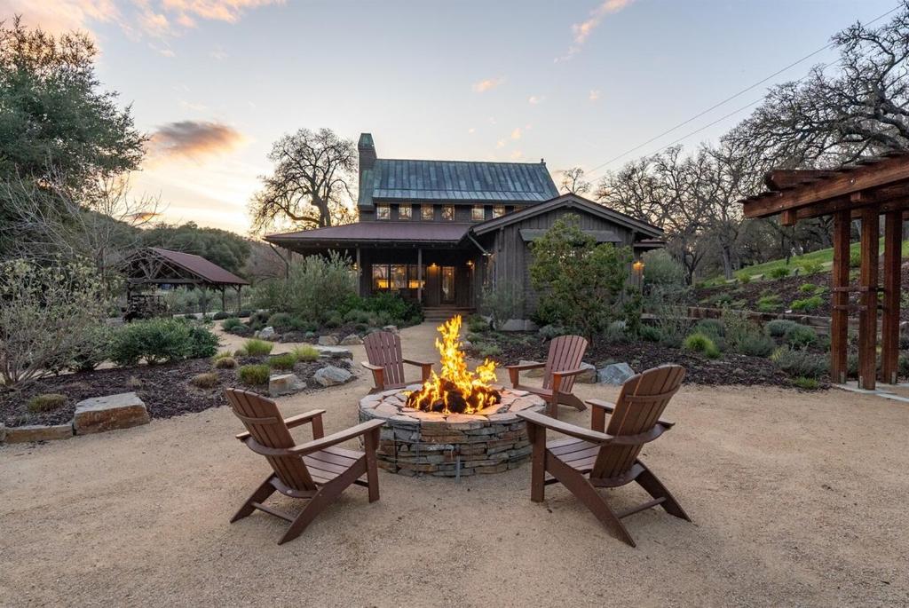 a fire pit in a yard with chairs and a house at Oaks & Madeira A Luxury Wine Escape in Paso Robles in Paso Robles
