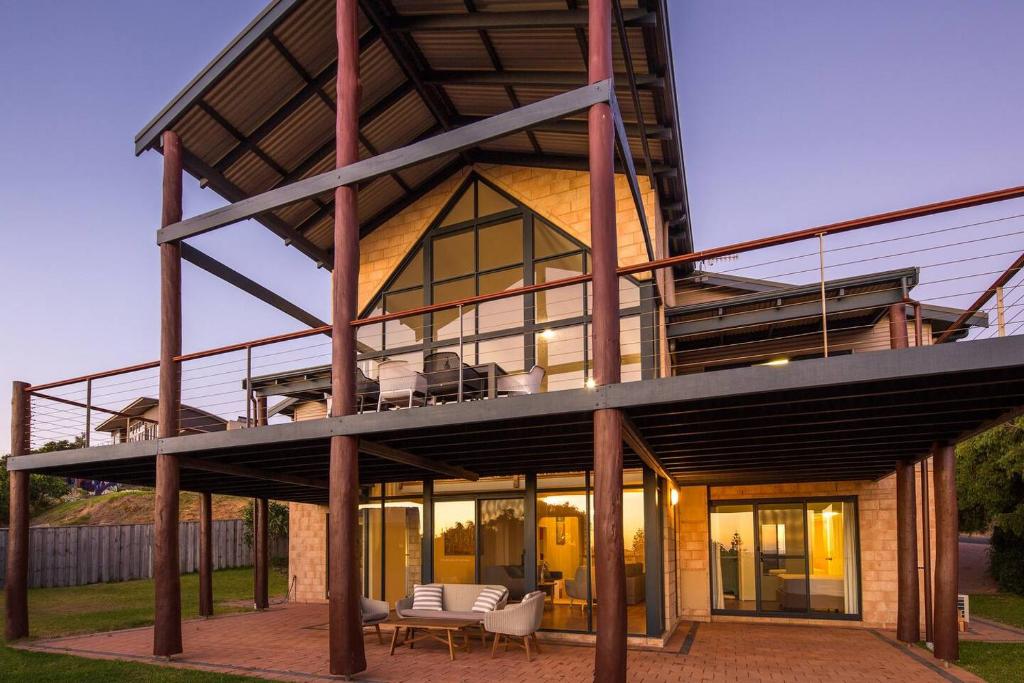 a large house with glass windows and a patio at Bondys Beach House - Panoramic Beachside Living in Prevelly