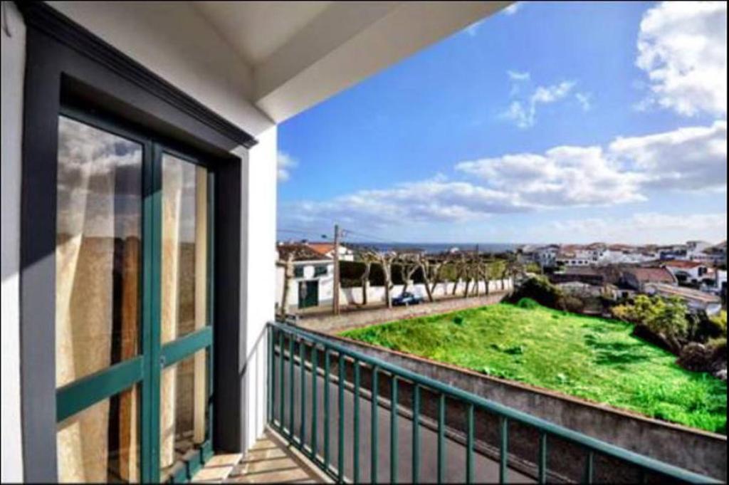a balcony with a view of a green field at Apartamento Tres Marias in Lagoa