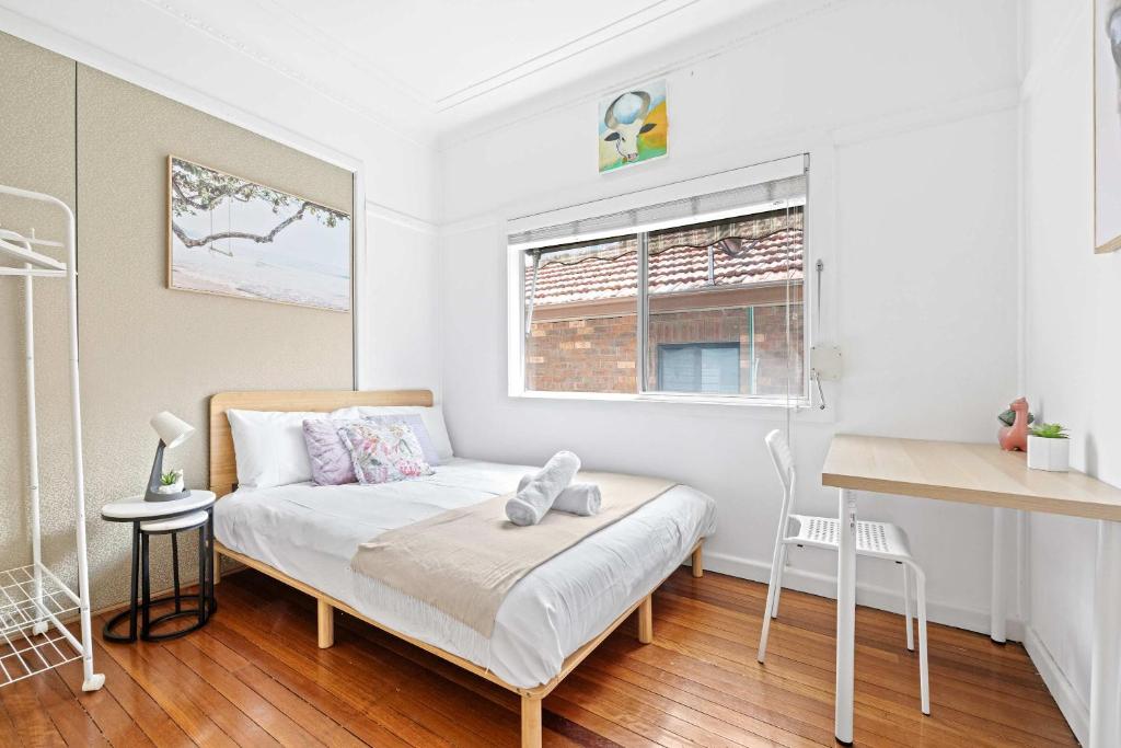 a small bedroom with a bed and a desk at Private Double Room - Centrally Located At Ryde - Shared Bathroom in Sydney