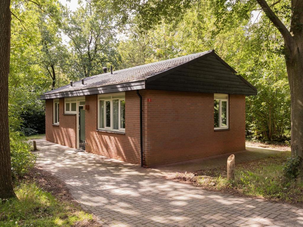 a small house in the middle of a forest at Bungalow in Putten near Veluwe Forest in Putten