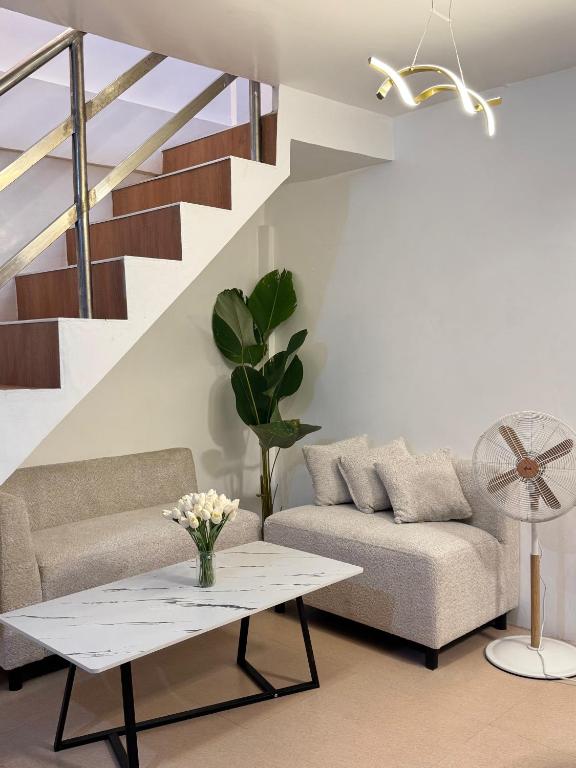 a living room with a couch and a table at Metro Naga Bnb 