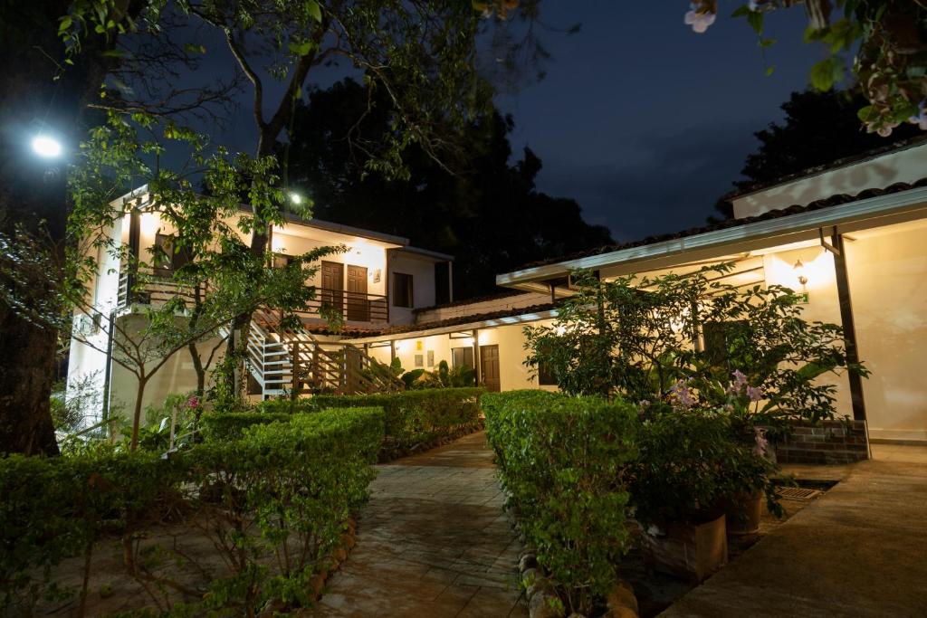 a house with a courtyard at night at Hotel Jardin De Las Marias in Suchitoto