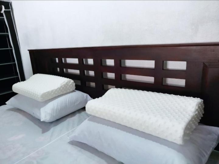 two white pillows sitting on top of a bed at Mango garden villa in Arugam Bay