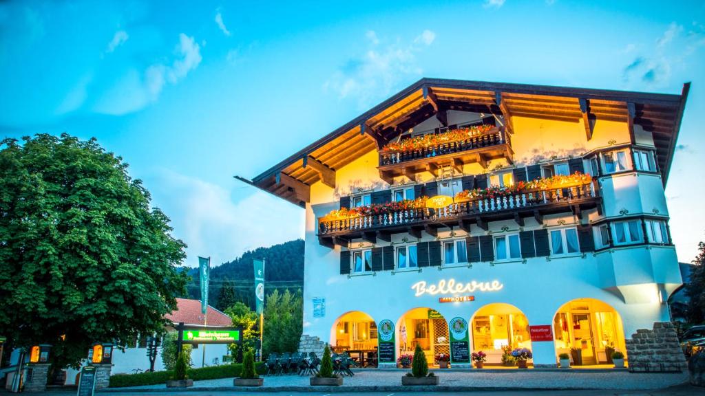 a hotel with a blue building at Hotel Bellevue in Bad Wiessee