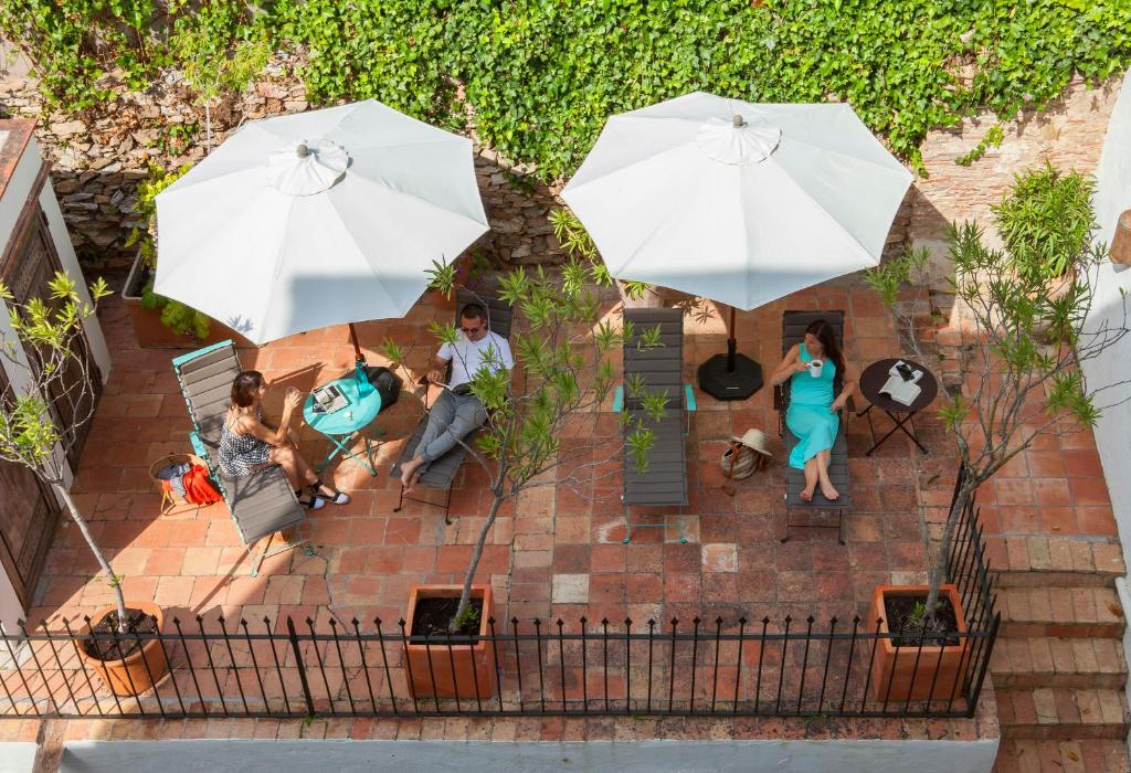 an overhead view of a group of people sitting under umbrellas at Hotel Hanoi in Begur
