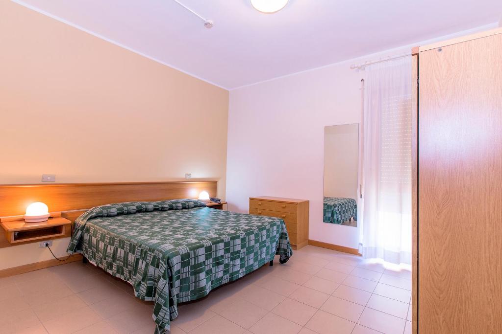 A bed or beds in a room at Hotel Residence Ulivi E Palme