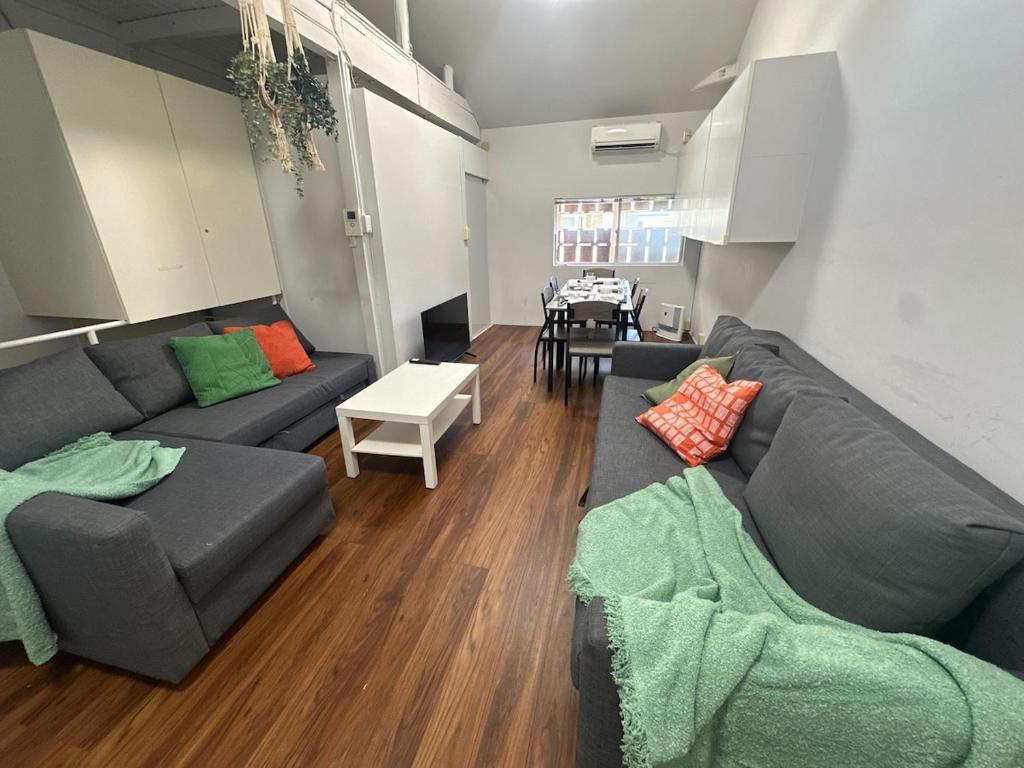 a living room with a couch and a table at 3BR Entire Home, 1 Min to Midosuji Line, Sleeps 10 in Osaka