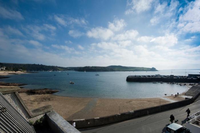 a view of a body of water with a beach at Seaspray in Saint Mawes