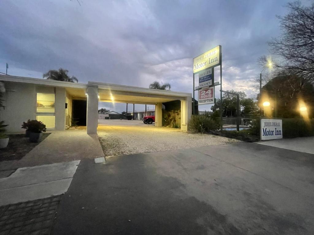 a gas station with a sign in front of it at Jerilderie Motor Inn in Jerilderie