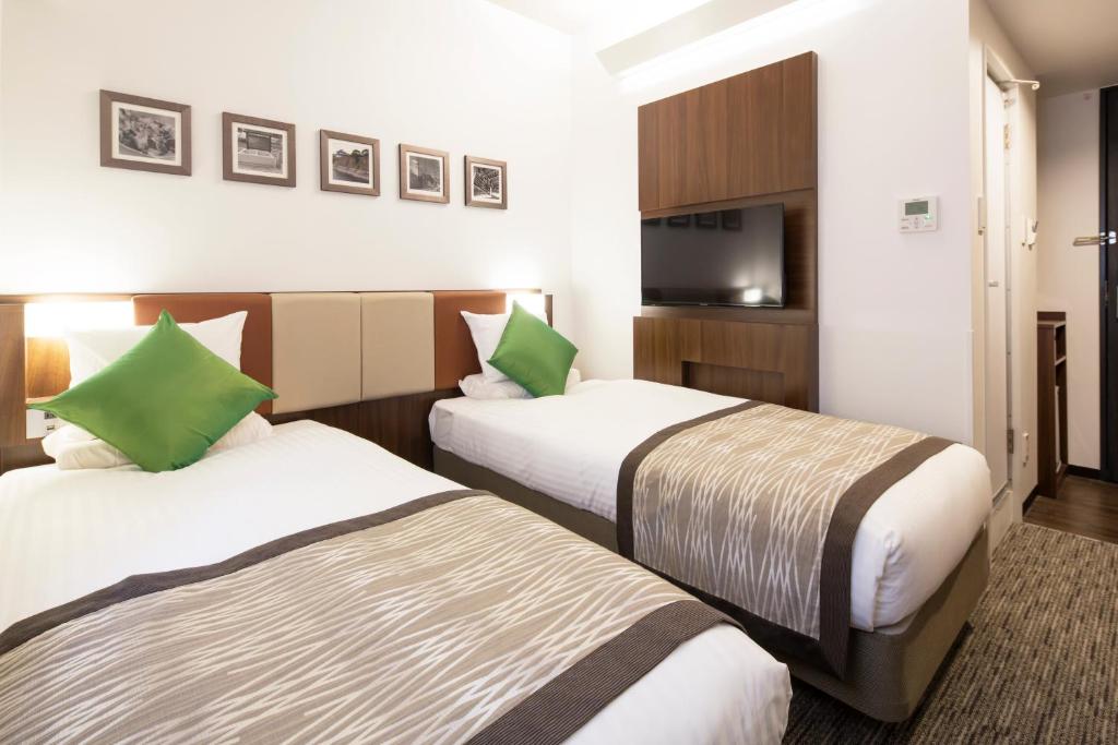 Postel nebo postele na pokoji v ubytování HOTEL MYSTAYS Shin Osaka Conference Center