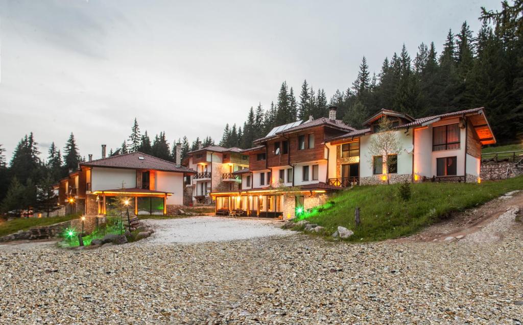a group of houses on a hill with trees at Boriki Complex in Pamporovo