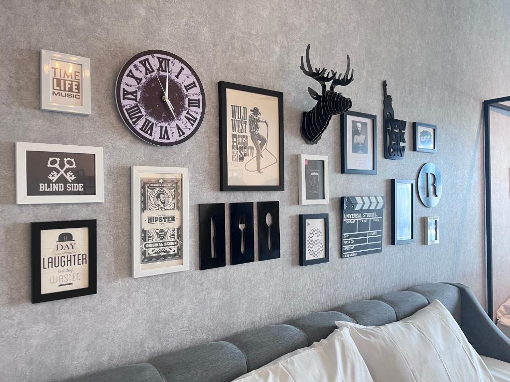 a wall with pictures and a clock on it at Edusphere near MMU UOC 2min Studio 2pax in Cyberjaya