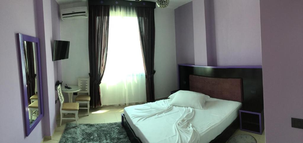 Postel nebo postele na pokoji v ubytování Hotel Siklad