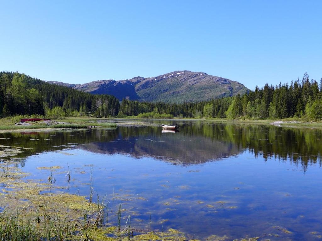 - un petit bateau sur un lac dans les montagnes dans l'établissement Velfjord Camping & Hytter, à Velfjord