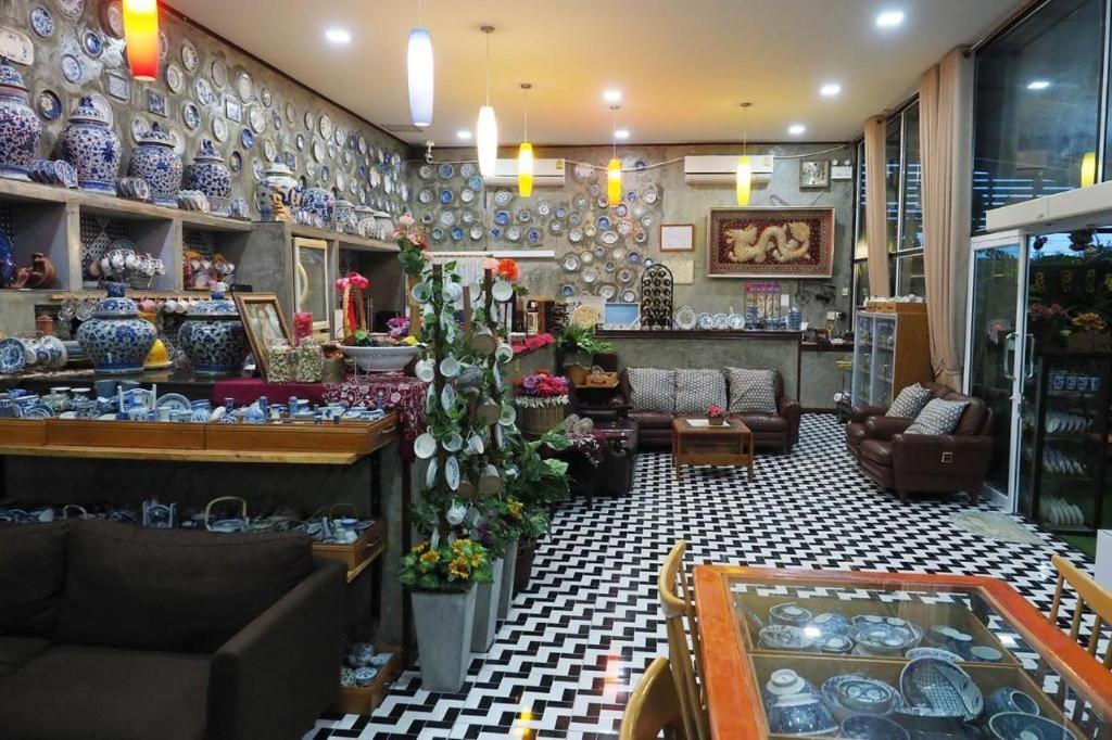 a store filled with lots of vases on the wall at Nawamit Home Garden in Nakhon Si Thammarat