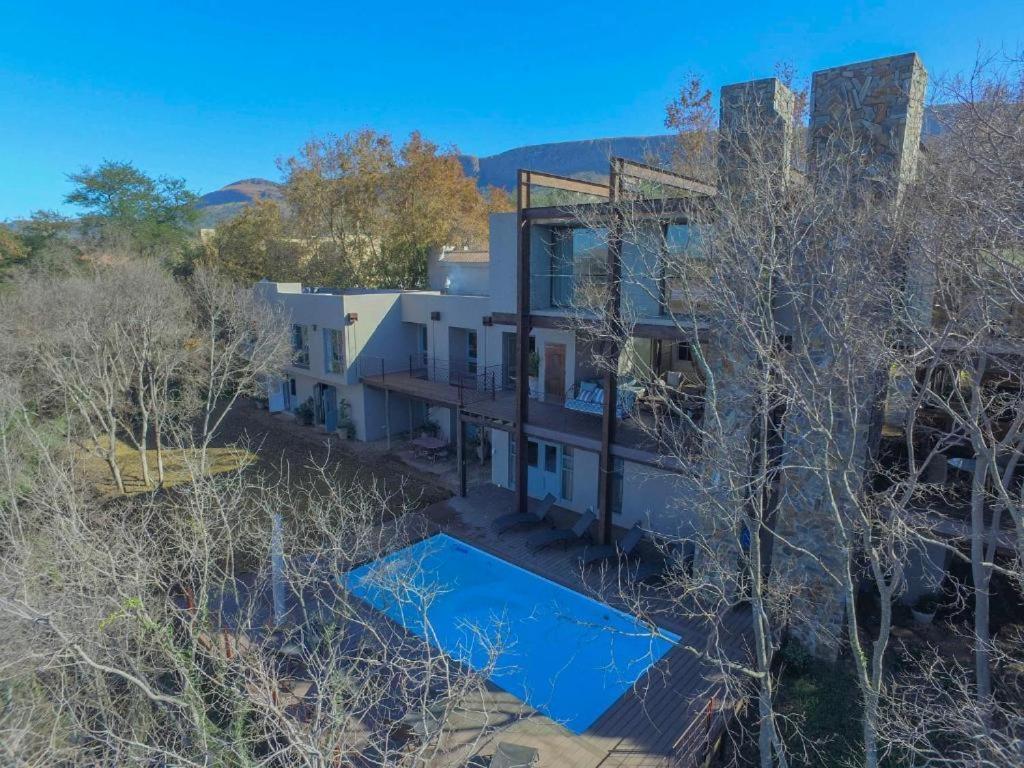 an aerial view of a white house with trees at La Serenita @ Migdash in Hartbeespoort