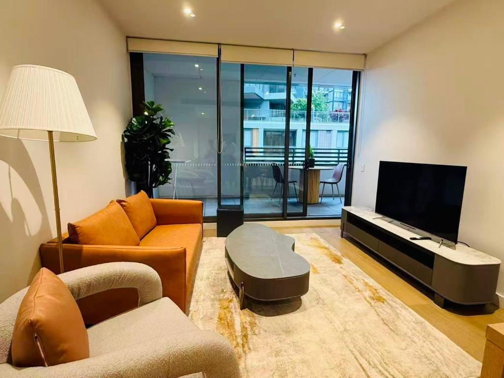 a living room filled with furniture and a flat screen tv at Darling Harbor living - Sydney 2 beds condo pool in Sydney