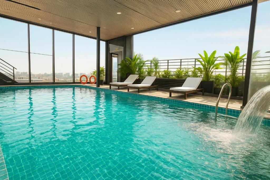 a swimming pool with a view of a building at Splendid Secret Hotel in Hanoi