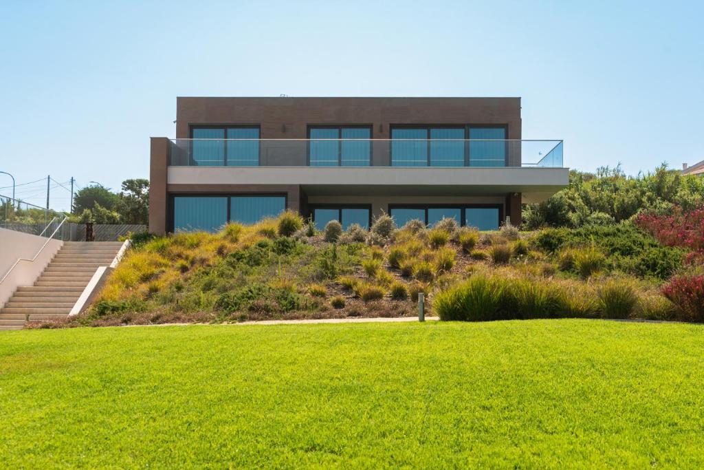 a house on a hill with a green lawn at Sintra Hills & Ocean View Luxury House in Colares