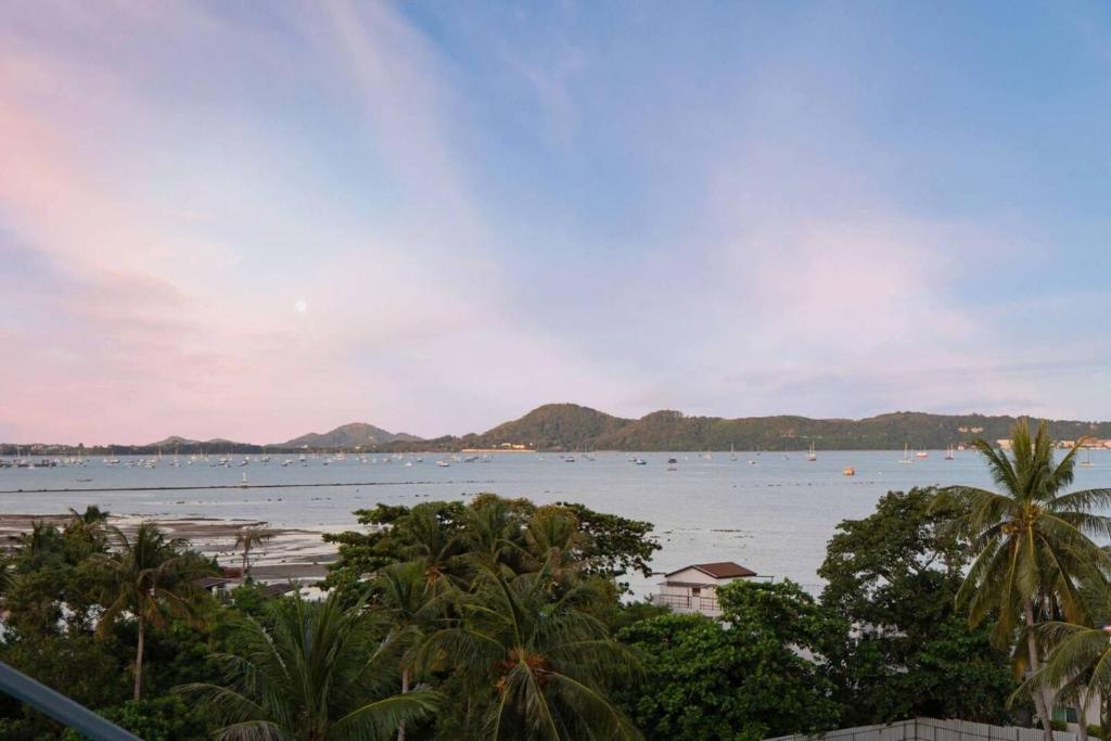 a view of a beach with boats in the water at Tranquil 2-Bedroom Getaway in Selina Serenity Phuket - Selina #870 in Ban Saiyuan (1)