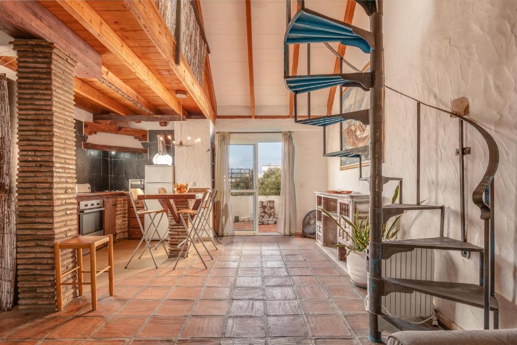 a living room with a staircase and a table at Rustico C in Tarifa