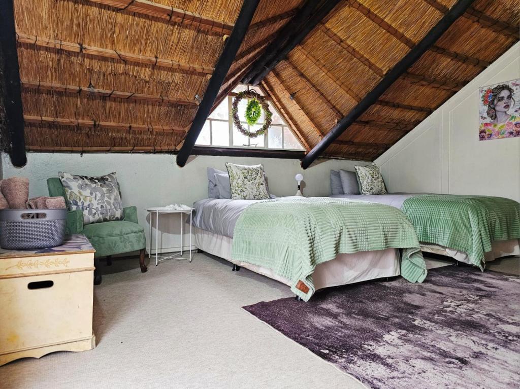 a bedroom with two beds and a window at Bergvliet Cottages - Salvado and Esparanza in Clarens