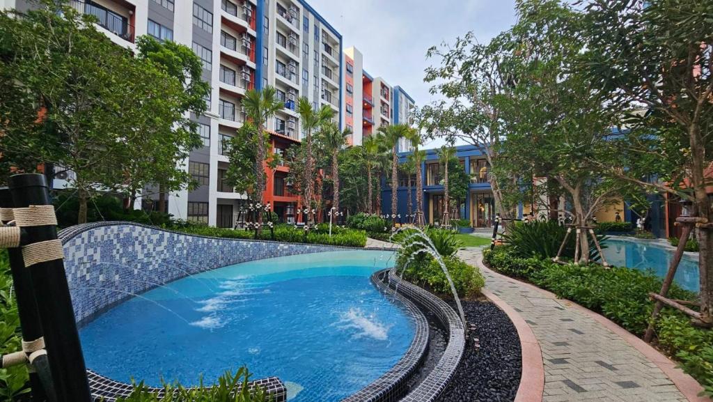 a swimming pool in the middle of a building at Cabanas Huahin by PTA in Hua Hin