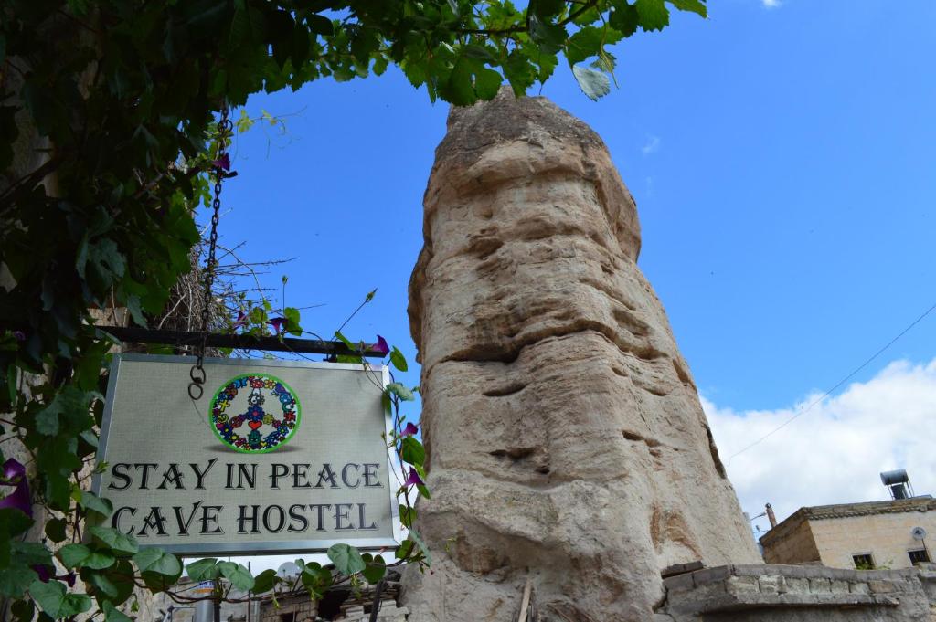 a statue of a lion sitting on top of a street sign at Stay In Peace Cave Hostel in Göreme