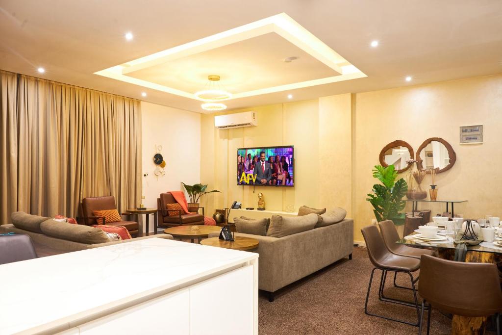 a living room with a couch and a table at 233 Boulevard by QUAO REALTY in Accra