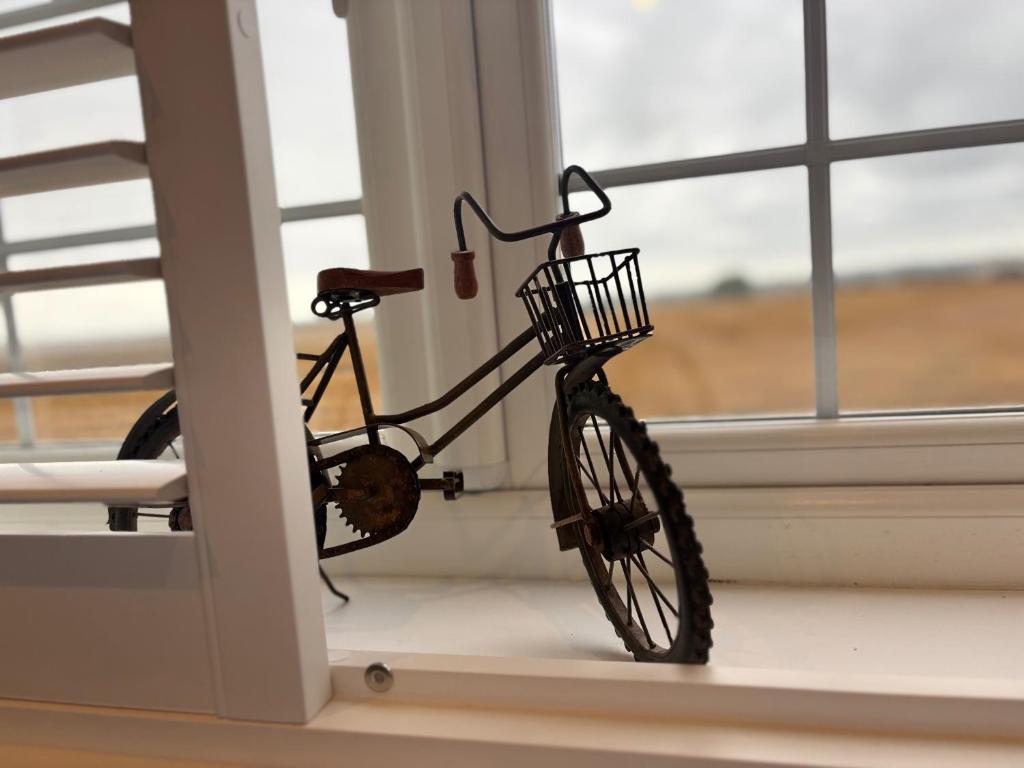 a bike sitting in a room next to a window at Tranquil Tenterden Apartment Retreat in Tenterden