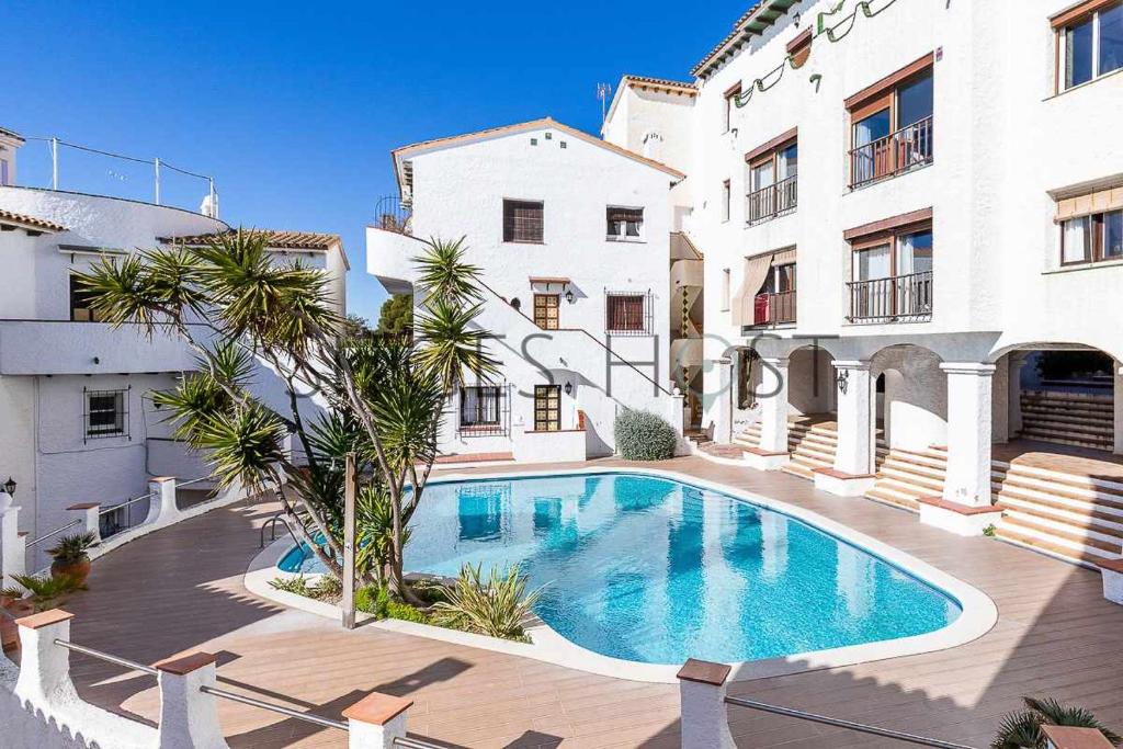 a swimming pool in the middle of a building at Sitges Blue - completamente reformado en 2025 in Sitges