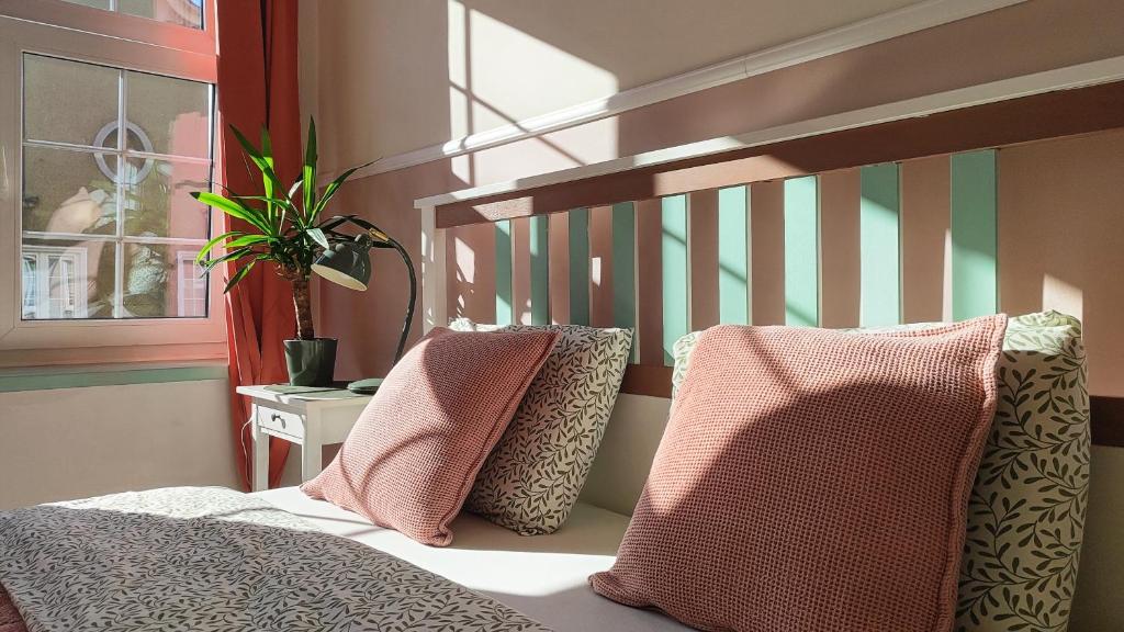 a bedroom with a bed with two pillows on it at Old Town Apartament next to Bazylika Mariacka in Gdańsk