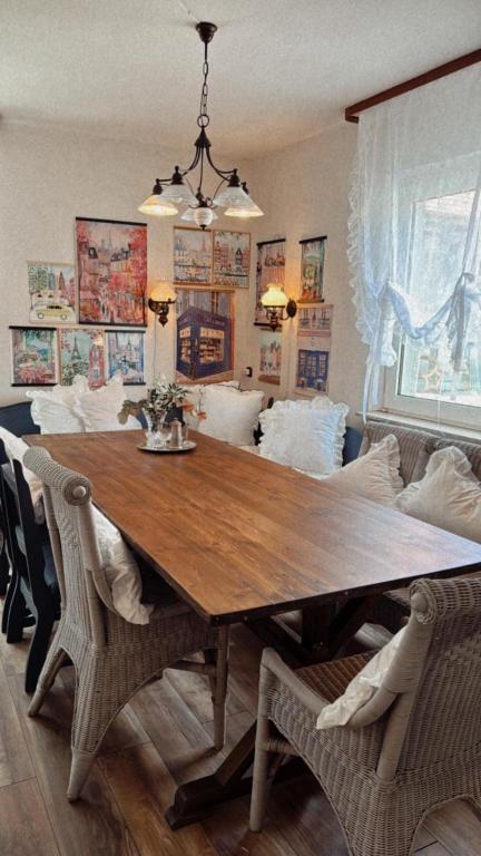 a dining room table with chairs and a couch at La!Maison am Rhein in Trebur