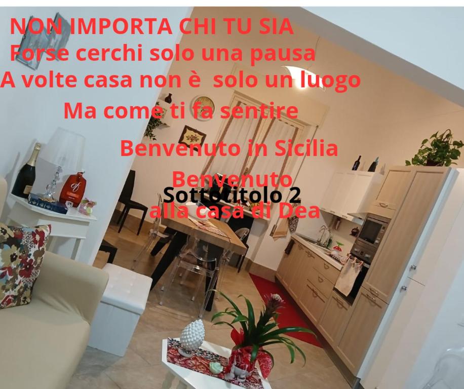 a living room with words on the wall at La casa di Dea in Marsala