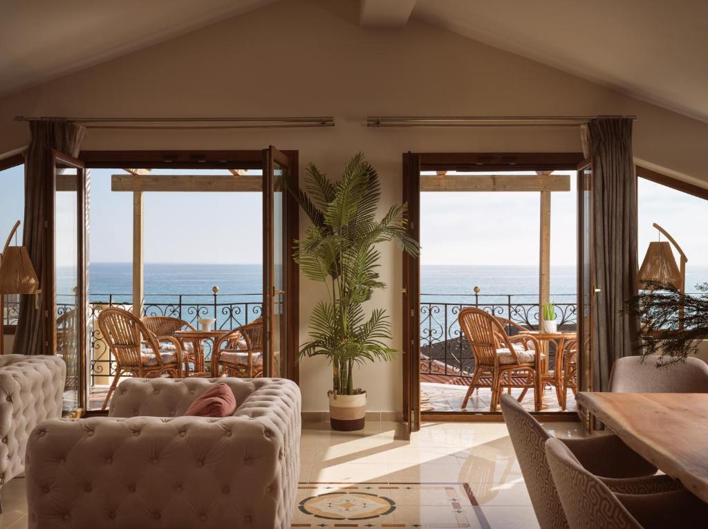 a living room with a view of the ocean at Casa Di Cuore Loft - Sea View & Jacuzzi Retreat in Argassi
