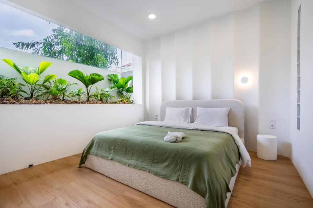 a bedroom with a bed with a teddy bear on it at Dreamland Villa by RESIDE 1BR Private Pool 3 min to Beach in Uluwatu