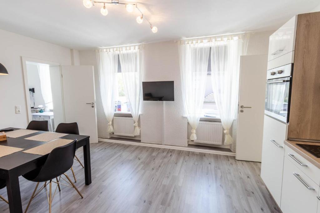 a kitchen and dining room with a table and chairs at AugsburgLiving - Business- und Ferienapartments in Augsburg