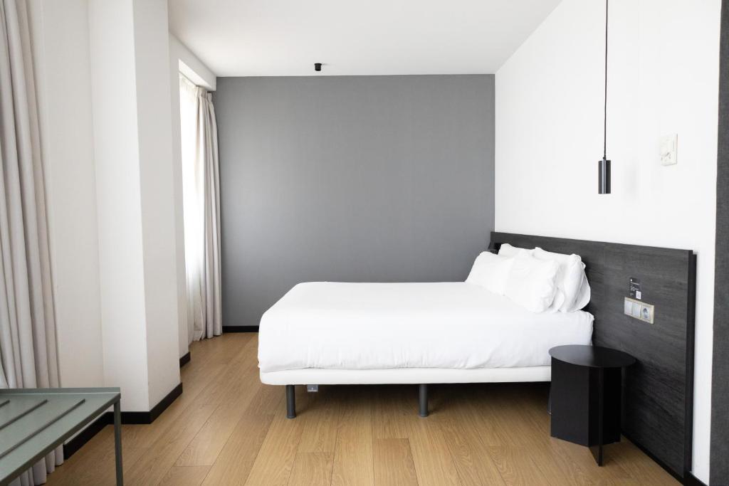 Ένα ή περισσότερα κρεβάτια σε δωμάτιο στο Hotel Forum Ceao