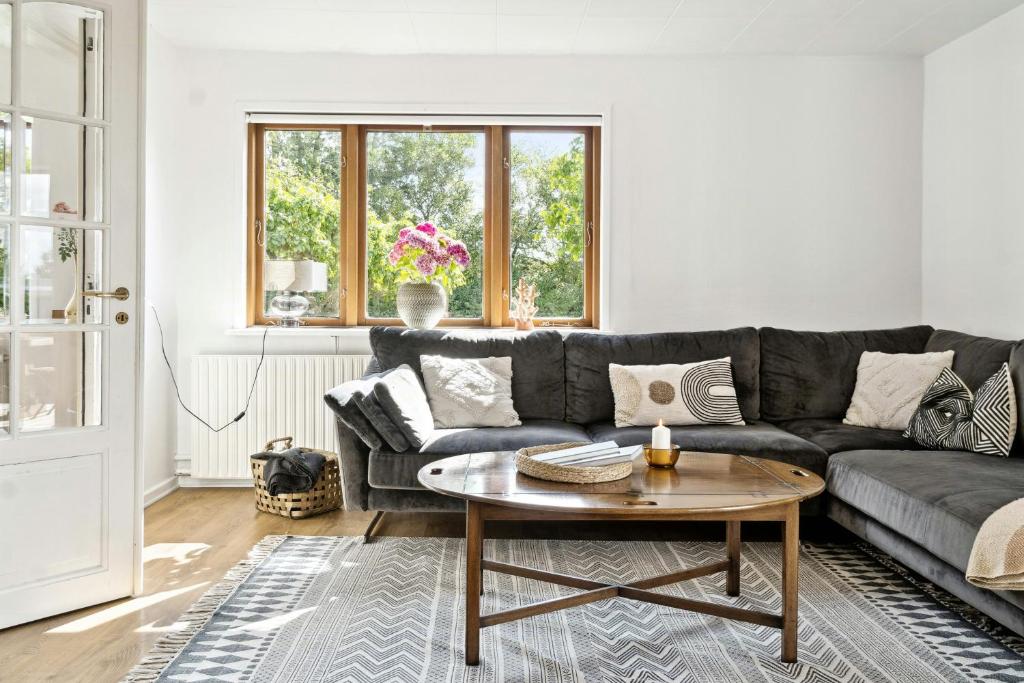 a living room with a couch and a table at Charming Holiday Home On The Island Of Fejø in Vejrø