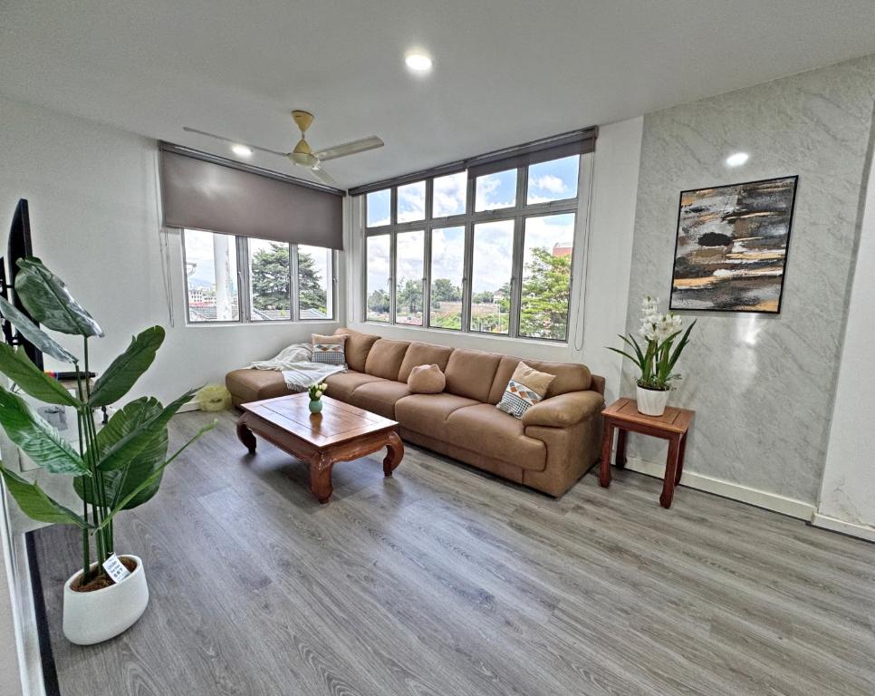 a living room with a couch and a table at Arena Lobak Villa Retreat, Spacious Stay with Billiards, Karaoke, BBQ in Seremban