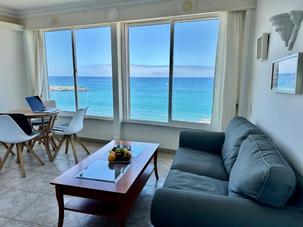 a living room with a couch and a table at Direct at the beach - Arguineguin in Arguineguín