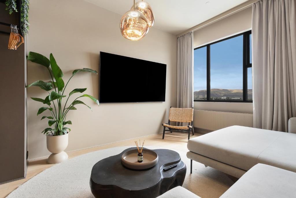 a living room with a bed and a table at Arctic Comfort Hotel in Reykjavík