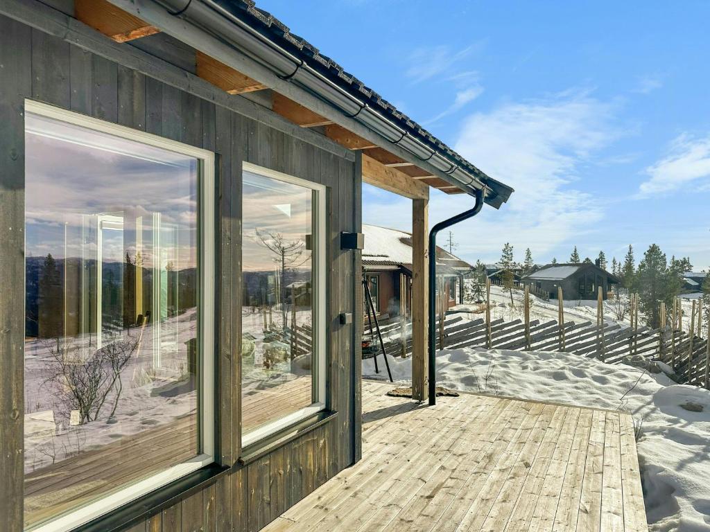 a house with sliding glass doors on a deck at Modern Mountain Cabin Near Norefjell in Eggedal
