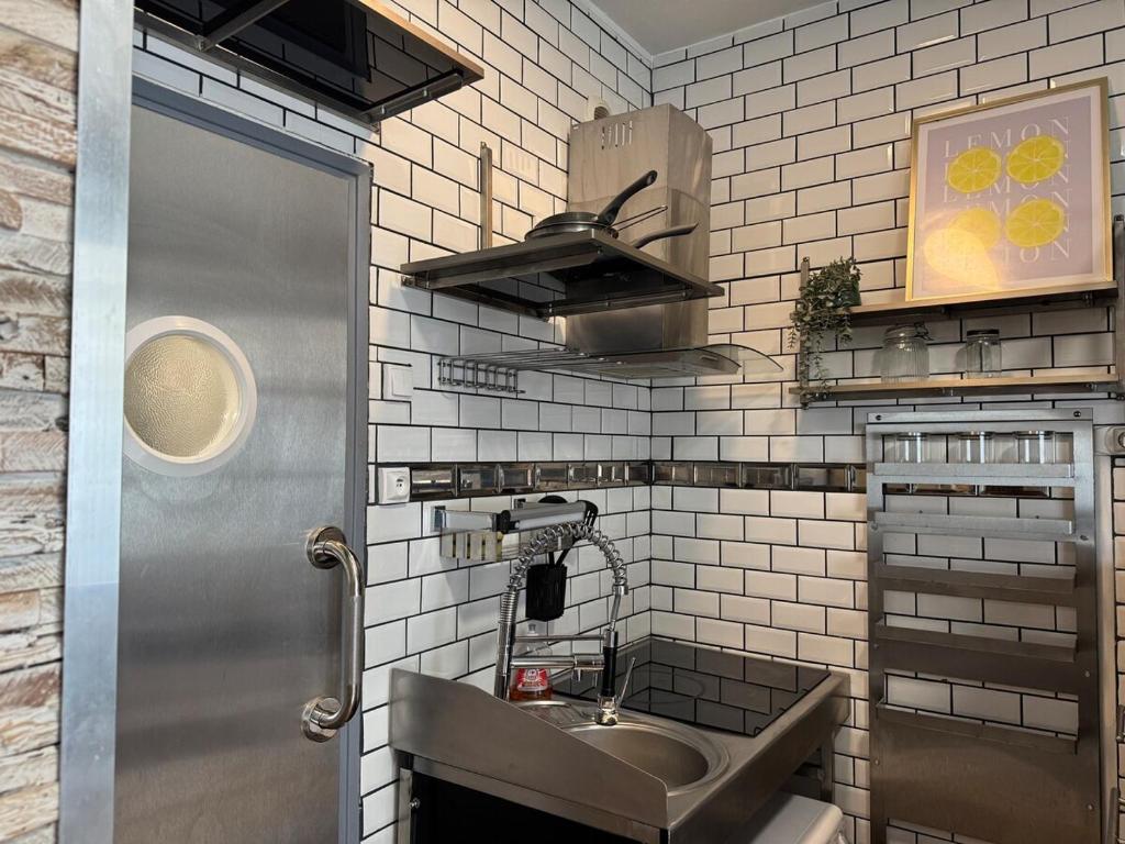 a small kitchen with a sink and a counter at Le Corsaire in Angers
